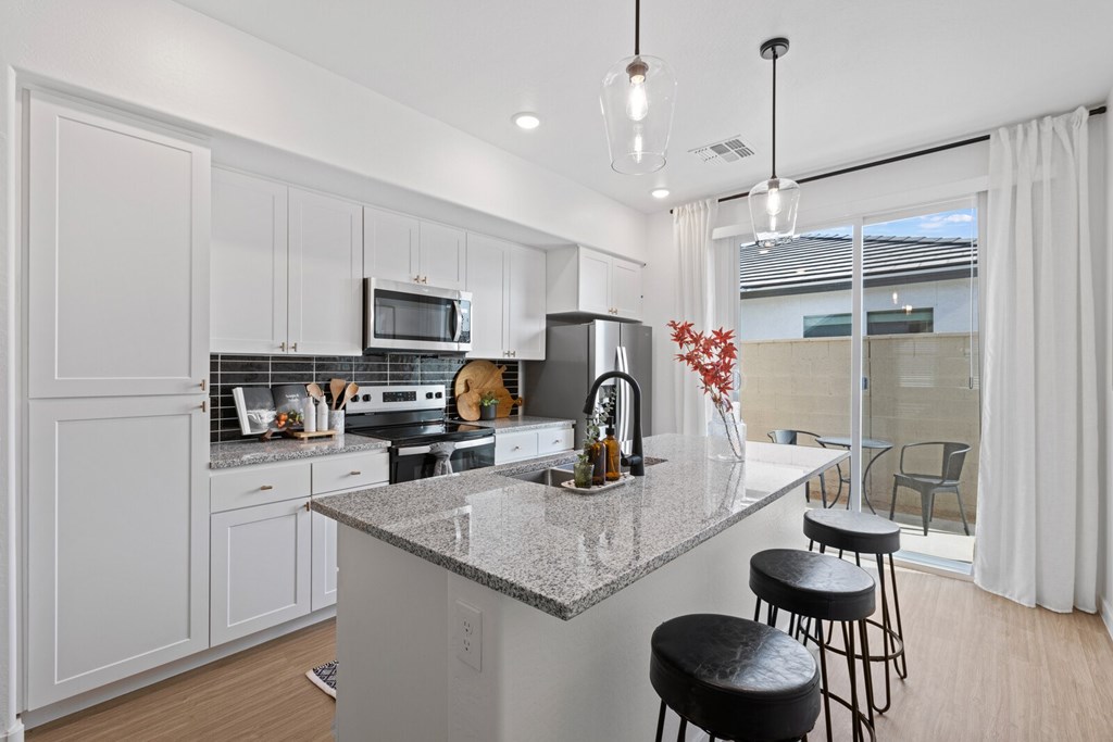Kitchen and patio at Pique Residences Apartments in San Tan Valley