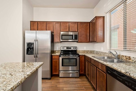 a kitchen with stainless steel appliances and granite counter tops