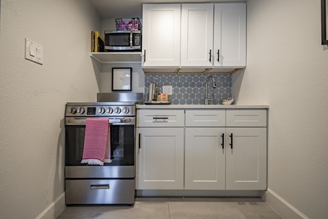 a kitchen with stainless steel appliances and white cabinets