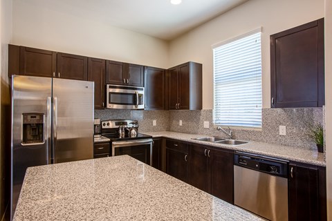 a kitchen with stainless steel appliances and granite counter tops