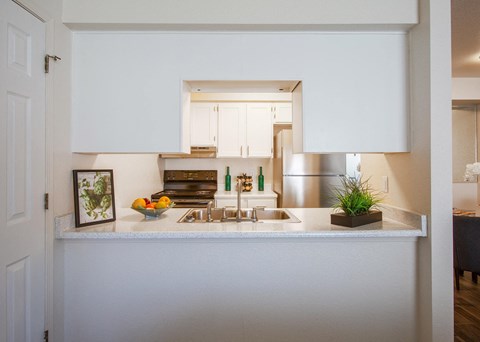 a kitchen with white cabinets and a sink