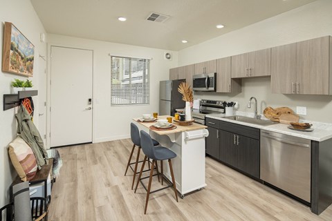 an open kitchen and dining area with a table and chairs