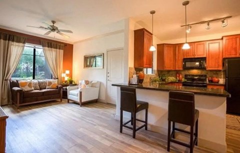 a kitchen and living room with a counter top