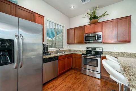 a kitchen with stainless steel appliances and granite counter tops
