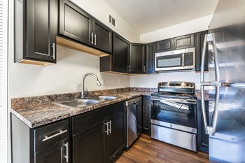 Kitchen with stainless steel appliances at Metro Tucson Apartments - Photo Gallery 4