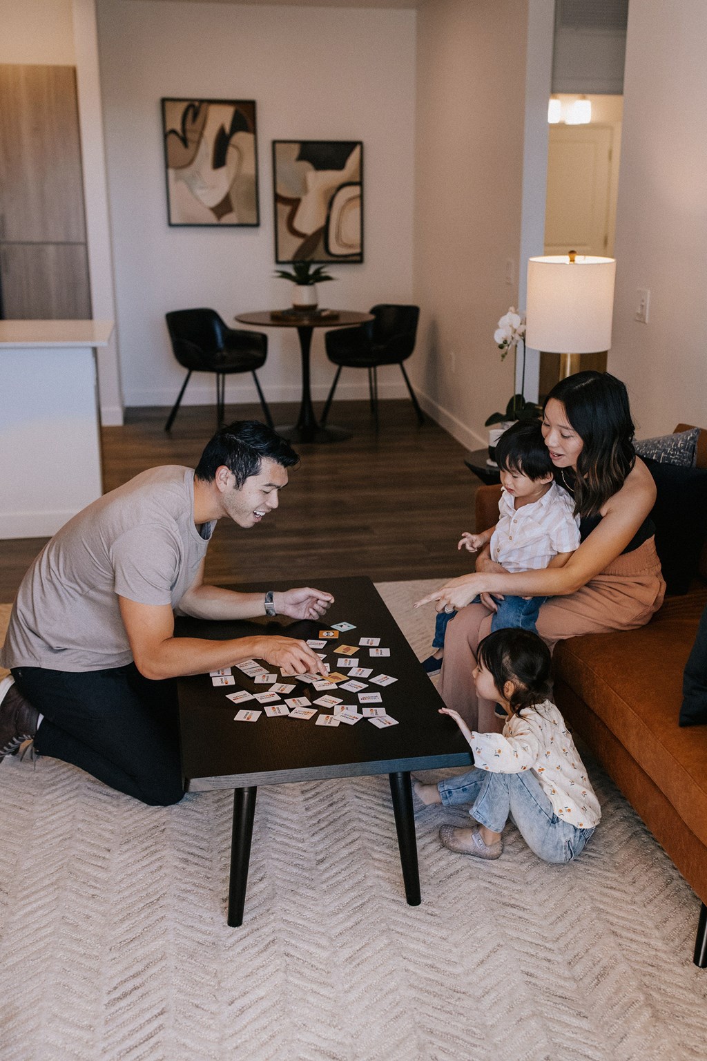 A family playing a board game together in their living room.