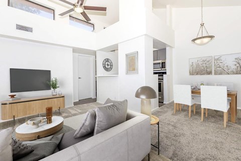 A living room with a grey couch and a wooden coffee table.