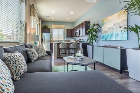 A modern living room with a grey sofa and a coffee table.