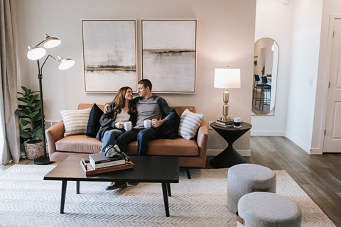 a man and woman sitting on a couch in a living room