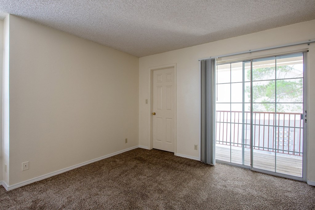 Living Room with Balcony at Park Place Apartments in Las Cruces