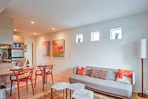 a living room with a couch and a table with chairs