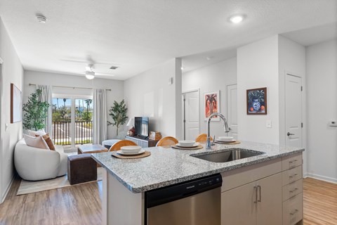 A modern kitchen with a dining table and chairs.