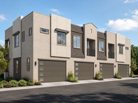 A modern house with a grey facade and black garage doors.
