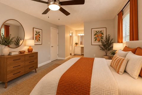 A bedroom with a large bed and a ceiling fan.