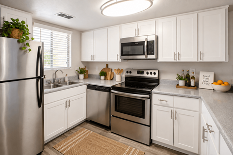 A kitchen with white cabinets and stainless steel appliances.