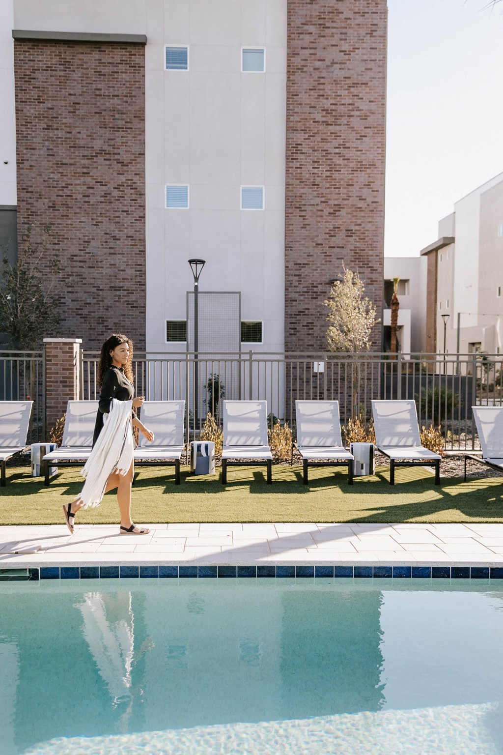 Pool with lounge seating at The Aster at Mountain Vista in Mesa Arizona