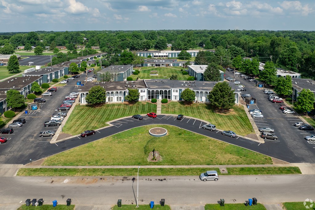 A large building with a circular driveway in front of it.