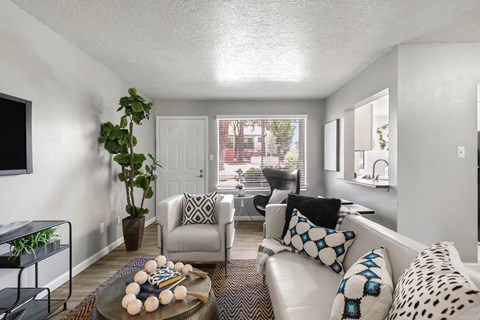 A living room with a white couch and a coffee table with decorations on it.