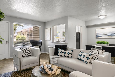 A living room with a white couch and a coffee table.