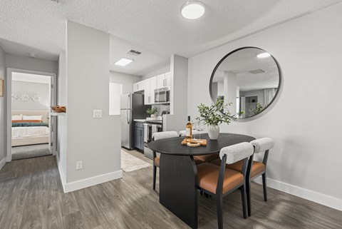 A modern kitchen with a dining table and chairs.