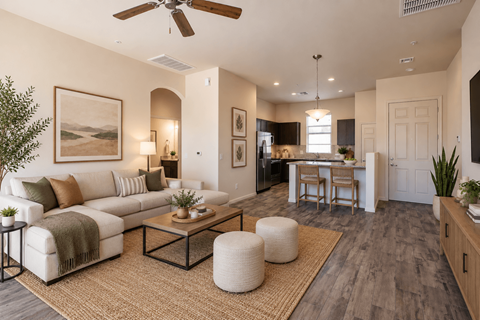 A living room with a white couch, a coffee table, and a ceiling fan.