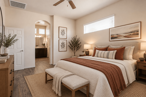 A bedroom with a large bed and a ceiling fan.