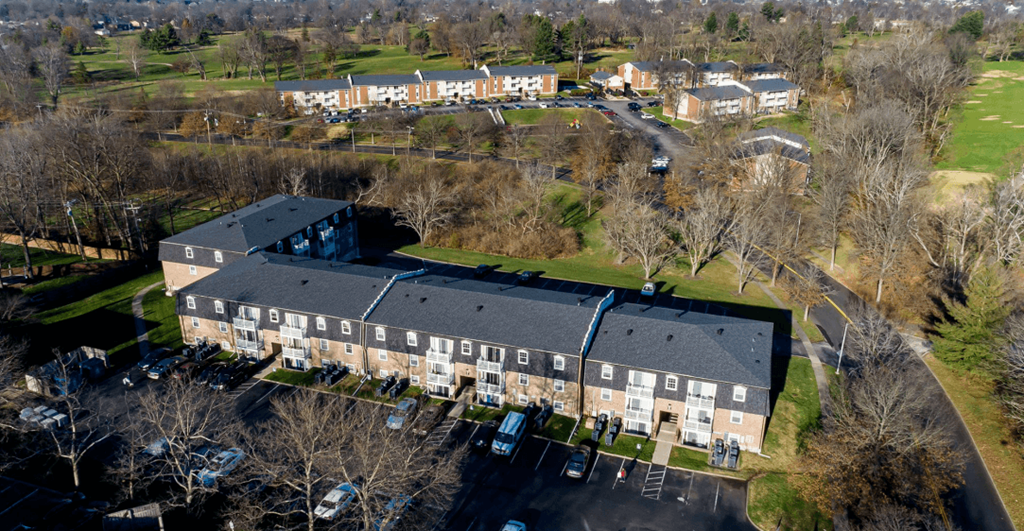 An aerial view of a parking lot in front of a building.
