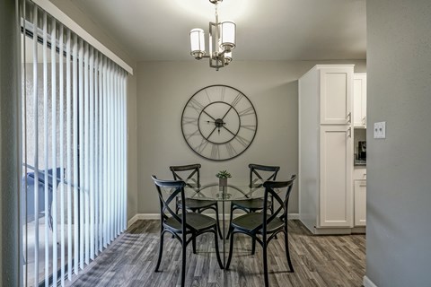 A dining room with a table set for four.