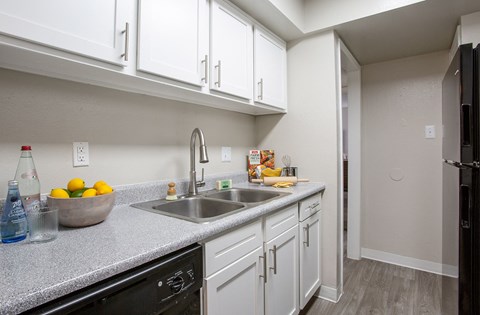 a kitchen with white cabinets and a sink