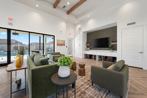 A living room with a couch, chairs, and a television.
