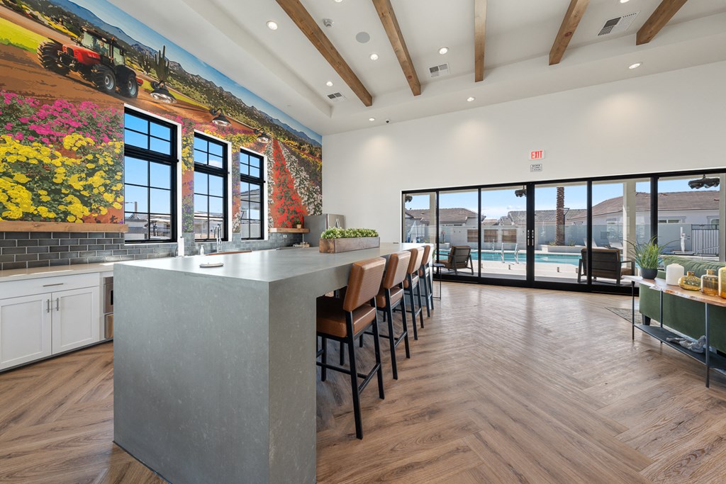 A large kitchen with a long island and a mural of a tractor on the wall.