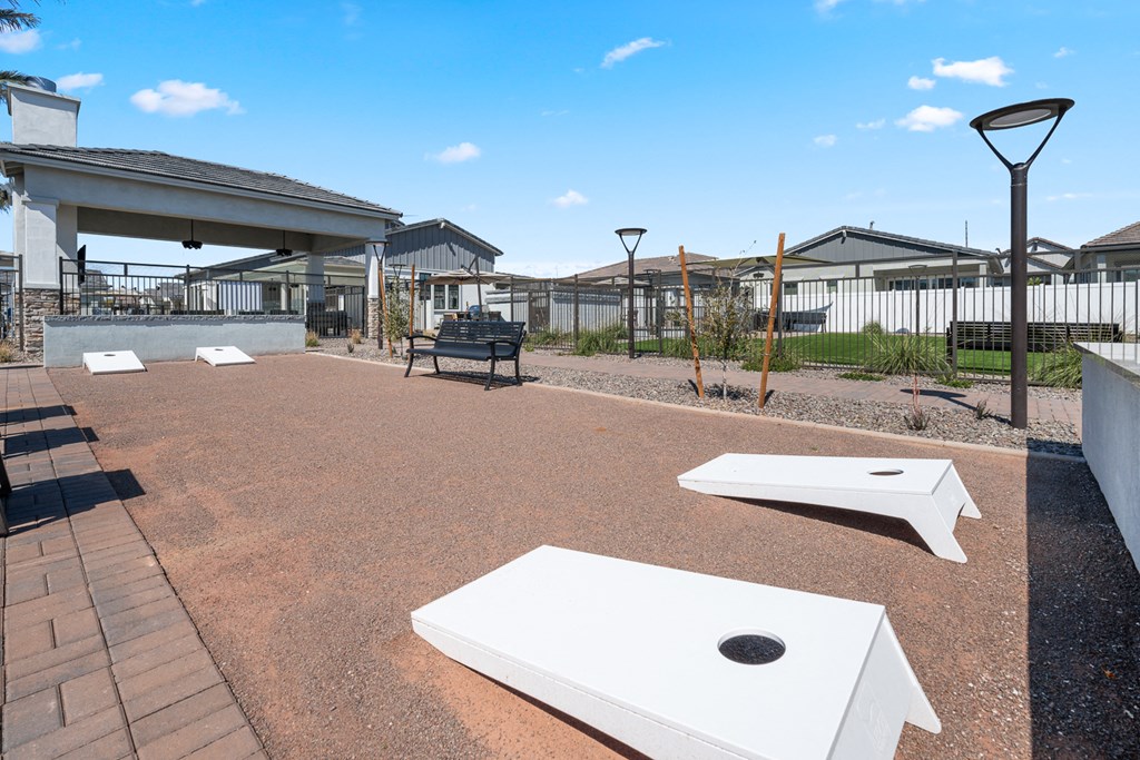 A playground with a slide, swings, and a basketball hoop.