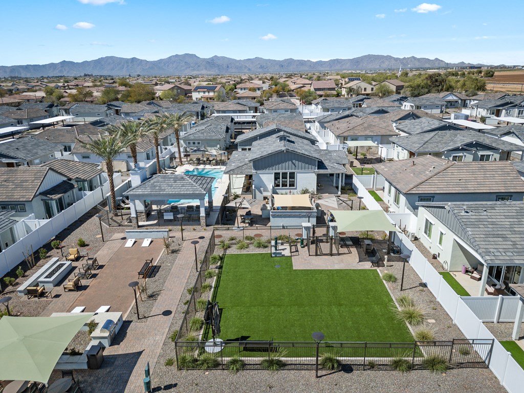 A large, well-maintained lawn is the centerpiece of a residential neighborhood.