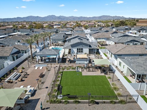 A large, well-maintained lawn is the centerpiece of a residential neighborhood.