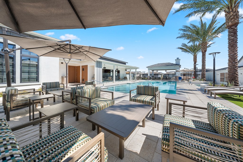 A sunny day at the poolside with a view of the surrounding area.