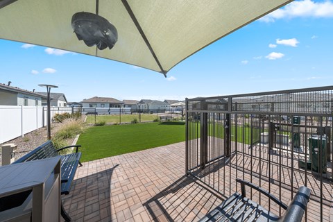 A patio with a table and chairs under a white canopy.