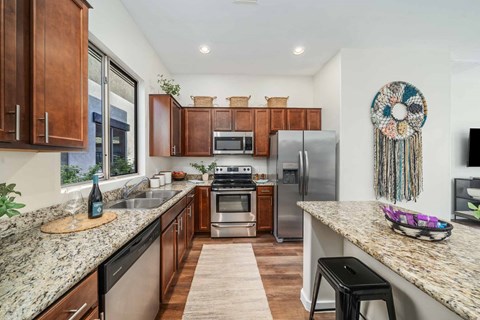a kitchen with stainless steel appliances and granite counter tops