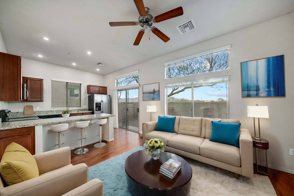 Spacious Living Room and Kitchen with Breakfast Bar at Avilla Preserve Apartment Homes in Tucson Arizona
