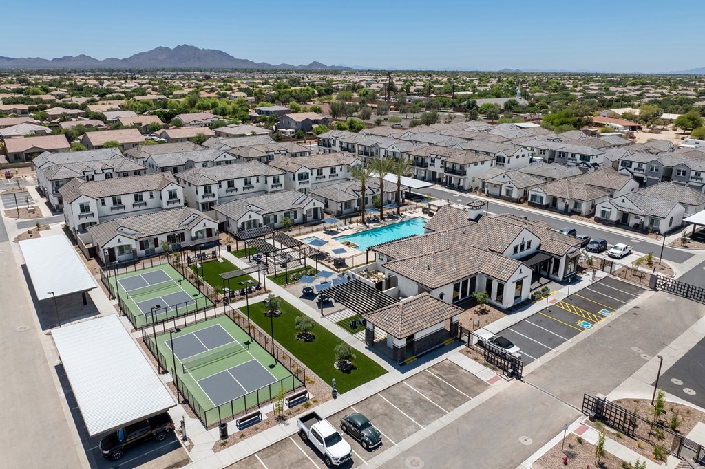 A large residential complex with tennis courts and a swimming pool.
