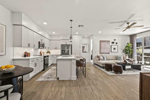 A modern kitchen with a dining table and chairs.