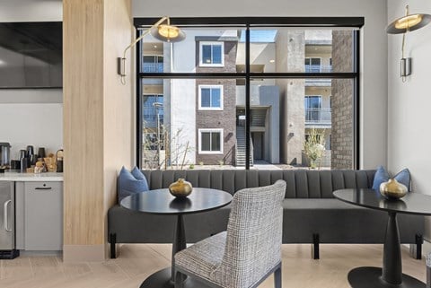 A modern dining room with a table and chairs.
