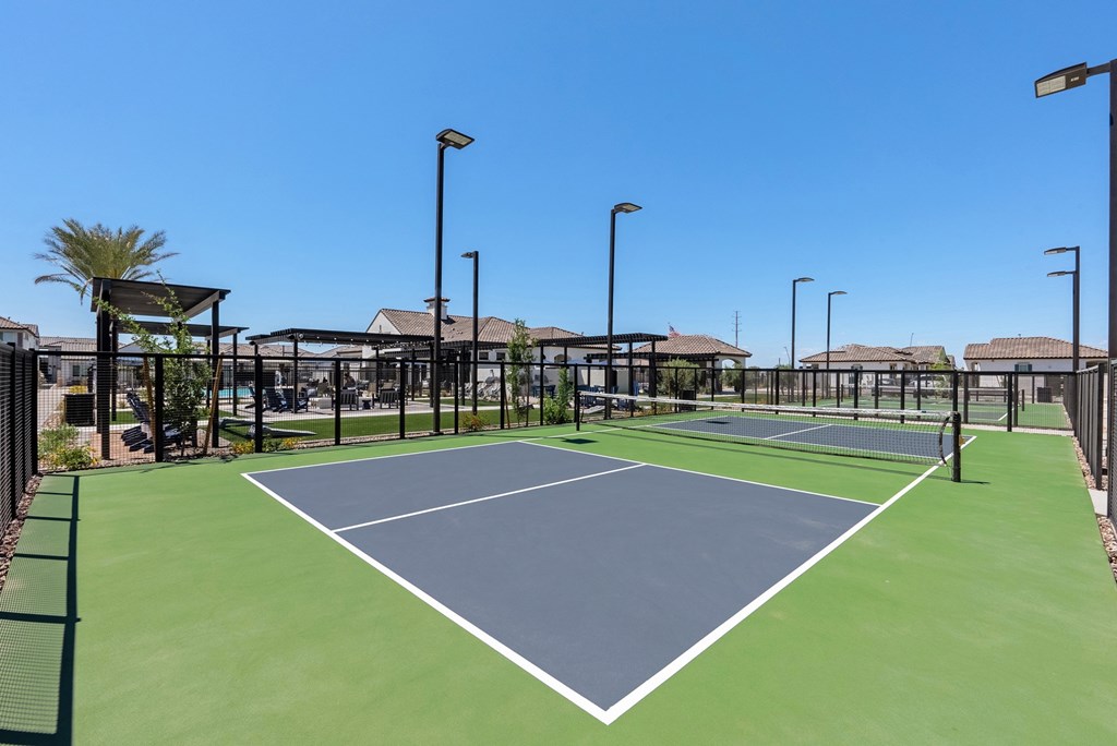 A tennis court with a green surface and white lines.