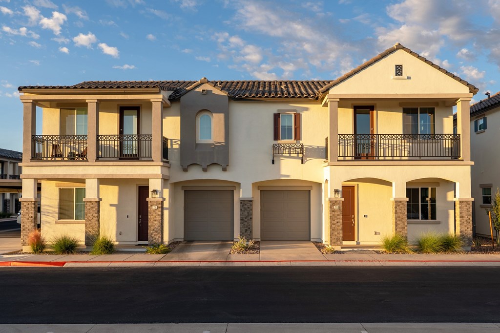 A two-story house with a balcony on the second floor.