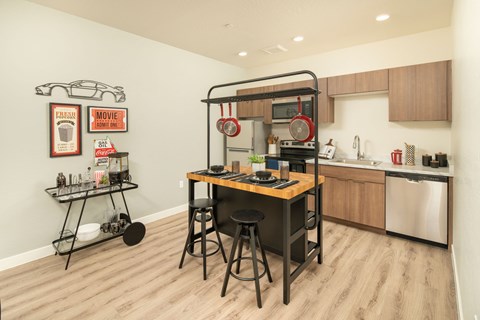 A kitchen with a table and chairs in the middle of the room.