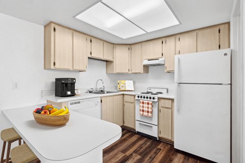 a kitchen with white appliances and wooden cabinets