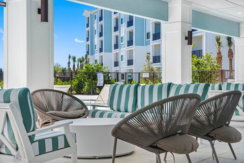 A white and green striped sofa sits in front of a building.