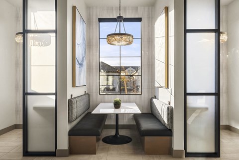 A modern dining room with a table and chairs.