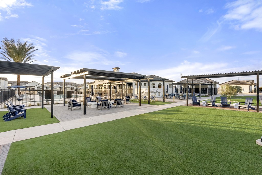 A sunny day at the park with a building in the background.