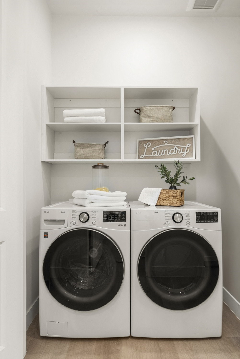 Two washing machines are in a laundry room.