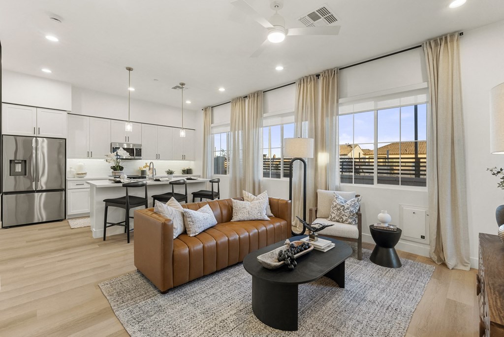 A modern living room with a brown leather sofa and a black coffee table.